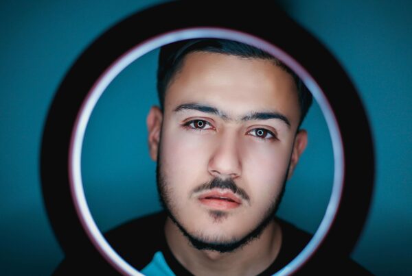 a male cam model in front of a ring light