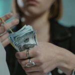 a findomme counting money earned from camming